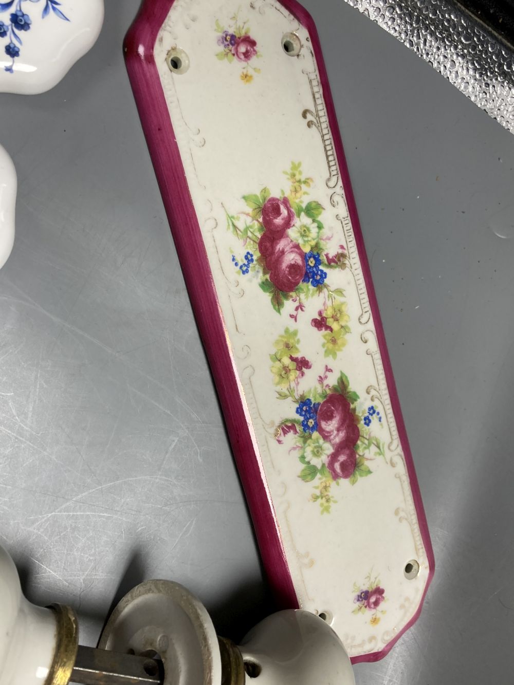 Five pairs of French porcelain door handles and ten porcelain door plates